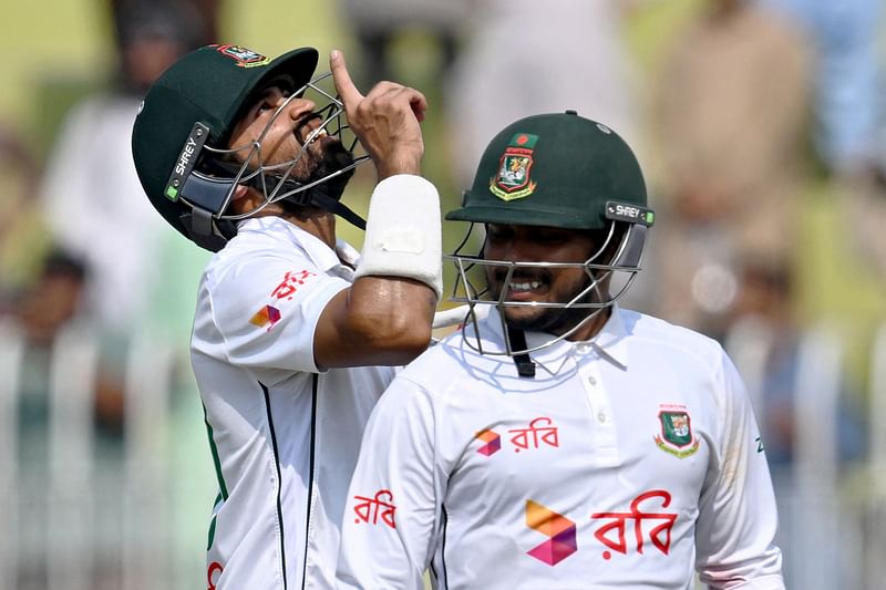 Bangladesh’s Shadman Islam (L) and Zakir Hasan celebrate after their team’s win during the fifth and final day of the first Test cricket match between Pakistan and Bangladesh at the Rawalpindi Cricket Stadium in Rawalpindi on 25 August 2024